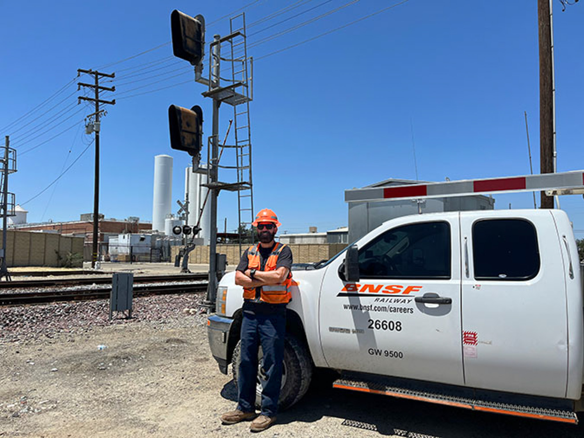 Chavez in front of a BNSF truck with train signals in the background Chavez in front of a BNSF truck with train signals in the background