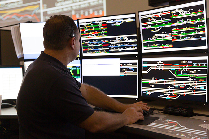 A BNSF dispatcher works in the Network Operations Center (NOC) in Fort Worth, Texas. A BNSF dispatcher works in the Network Operations Center (NOC) in Fort Worth, Texas.