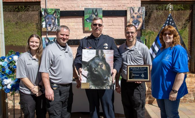 Schaffer at the WRTP K-9 memorial holding a photo of Faust. Schaffer at the WRTP K-9 memorial holding a photo of Faust.