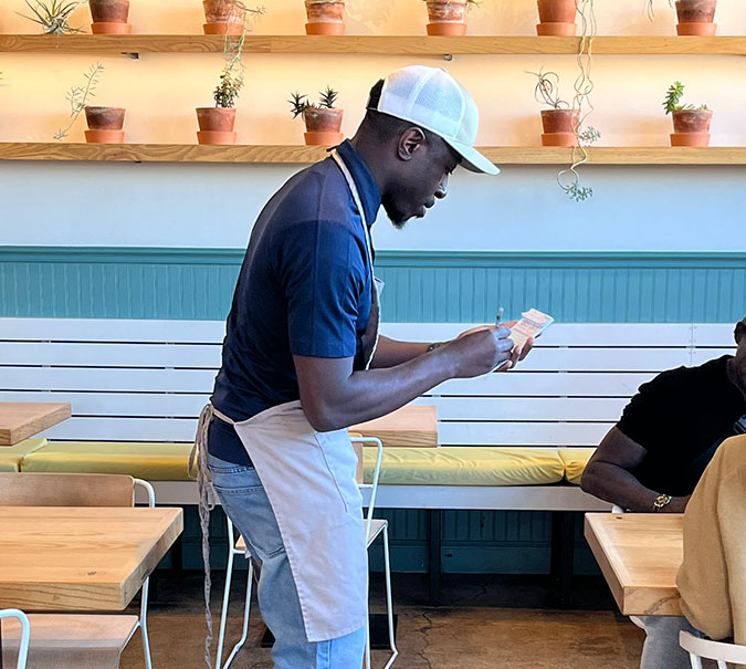 Richard Olaniyi takes an order during the BNSF volunteer day at Taste. Richard Olaniyi takes an order during the BNSF volunteer day at Taste.