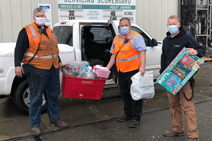 Darius LaPierre, right, and coworkers load donations. Darius LaPierre, right, and coworkers load donations.