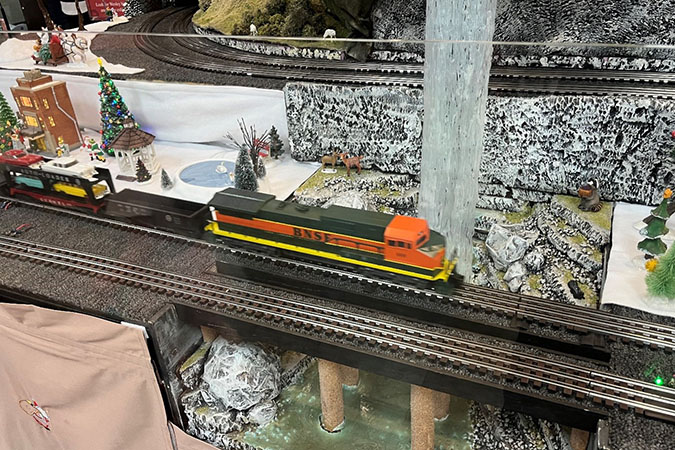 BNSF train crossing a bridge with a waterfall in the background BNSF train crossing a bridge with a waterfall in the background