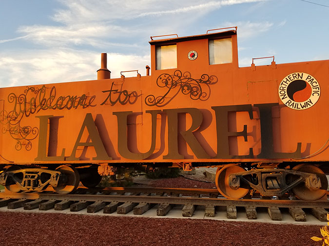 Welcome to Laurel sign in the shape of a caboose with Northern Pacific Railway logos Welcome to Laurel sign in the shape of a caboose with Northern Pacific Railway logos