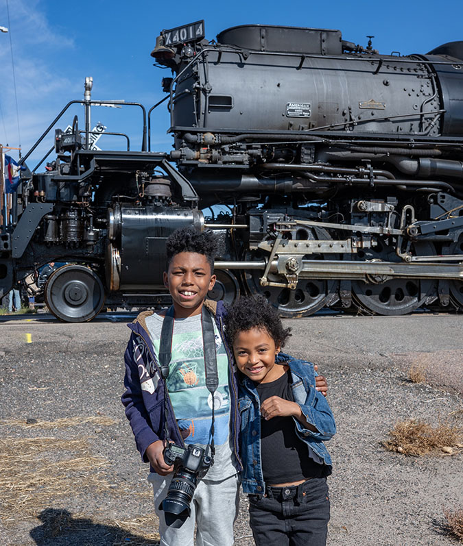 Daecian and his sister Kate standing in front of a steam locomotive. Daecian and his sister Kate standing in front of a steam locomotive.