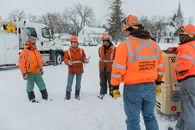 Crew members start their workday with a safety briefing. Crew members start their workday with a safety briefing.