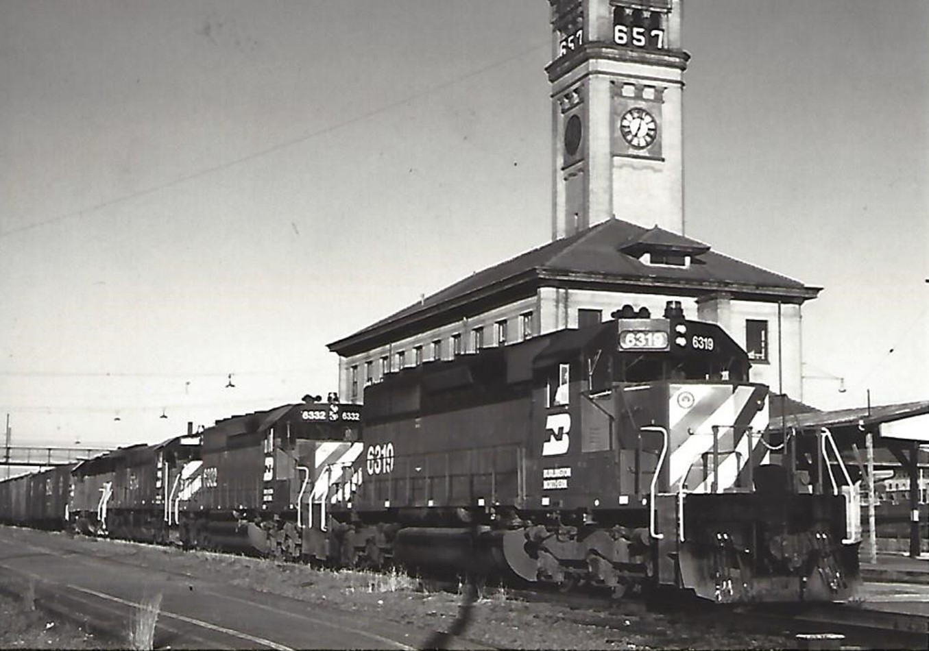 A Burlington Northern train at the Great Northern depot and clock tower, circa 1972. The “657” on the clock tower is a countdown clock, indicating 657 days until the start of the World’s Fair/Expo. A Burlington Northern train at the Great Northern depot and clock tower, circa 1972. The “657” on the clock tower is a countdown clock, indicating 657 days until the start of the World’s Fair/Expo.