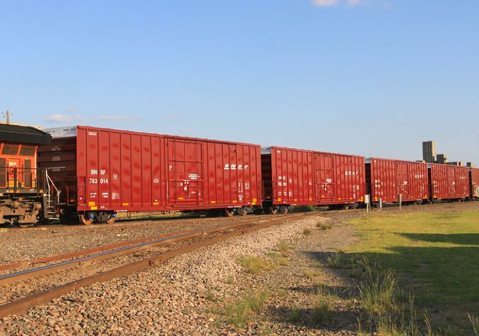 A BNSF train moves packaged sugar in boxcars. A BNSF train moves packaged sugar in boxcars.